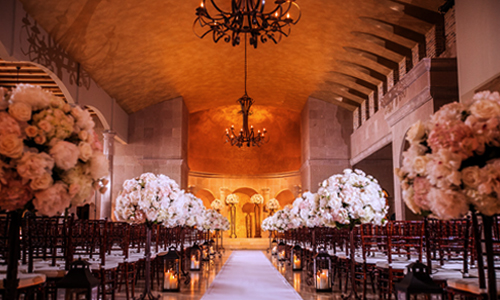 Indoor Ceremony Aisle with Floral Arrangements at The Bell Tower on 34th