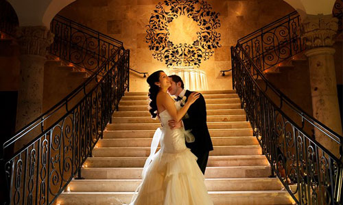Newlyweds Embrace on the Grand Staircase at The Bell Tower on 34th