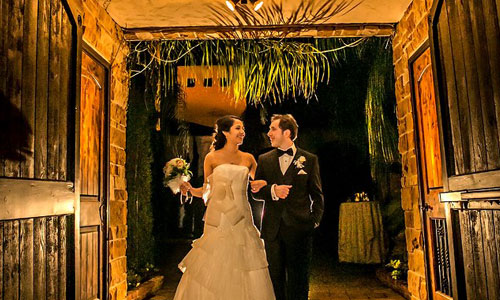 Couple Entering the Decorated Reception Tunnel at The Bell Tower on 34th